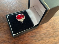 BEAUTIFUL SILVER PLATE DRESS RING WITH A RED STONE SIZE N FANCY SIDES
