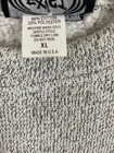 Gray vintage pullover sweater with black trim, white label showing fiber content, machine wash, and “Made in U.S.A.”