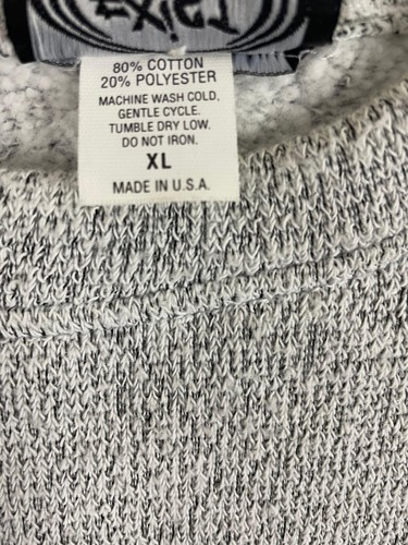 Gray vintage pullover sweater with black trim, white label showing fiber content, machine wash, and “Made in U.S.A.”