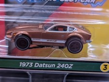 New Auto World Xtraction 1973 Datsun 240z HO Scale Slot Car Carded  Gold 