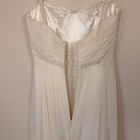 Ivory silk wedding dress with ruched front, fitted bodice, flared skirt, and gold zipper hardware made in USA.
