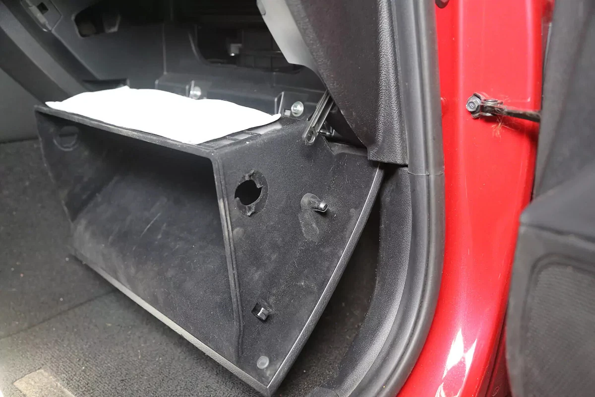 The vehicle's glove box door lowered.