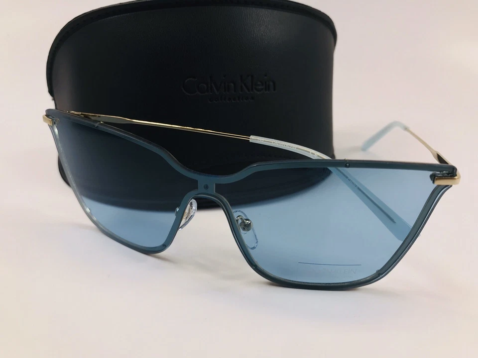 Nuevo Calvin Klein CK18115S 448 Gafas de sol con escudo azul claro y dorado con estuche