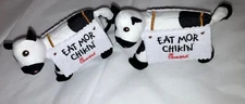 Two Chick Fil A Cow Eat Mor Chik'n Plush Wearing Sandwich Board