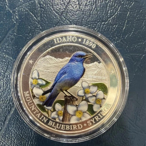 1 troy oz .999 Fine Silver Idaho 1890 State Bird Flower And Flag Colored Coin