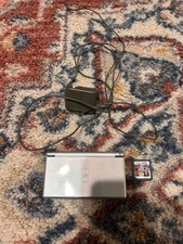 Nintendo DS Lite handheld console with charger and game