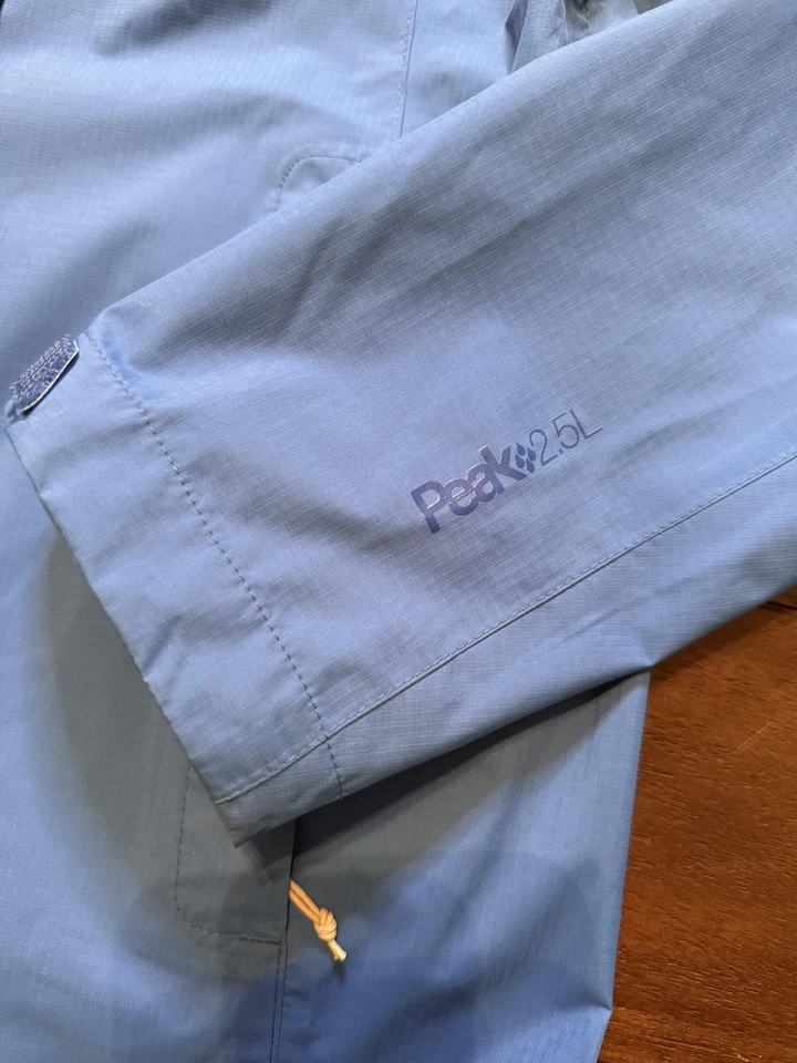 Chaqueta de lluvia cooperativa REI para mujer pequeña azul con capucha impermeable pico 2,5 L transpirable Foto 4 de 4