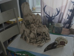 stone-like aquarium decoration featuring a rocky mountain structure with an...