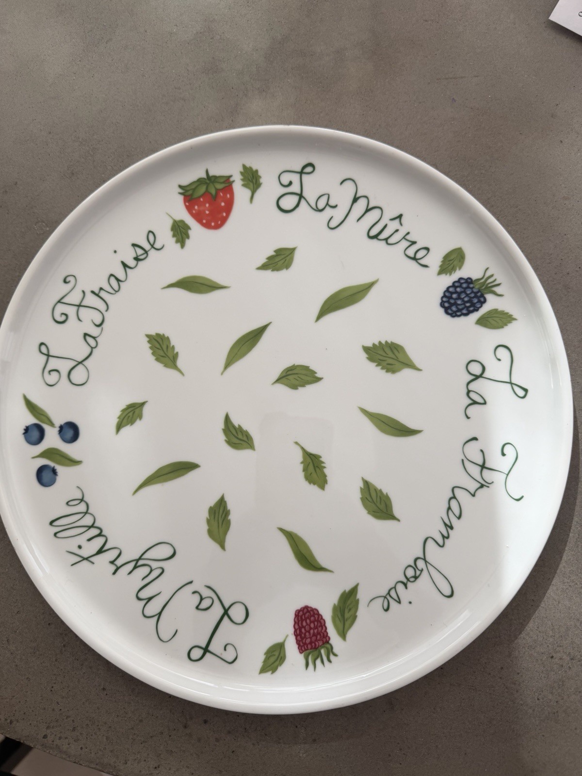 Philippe Deshoulieres Apilco porcelain plate with a fruit design. 11 7/8"