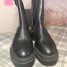 Black leather platform boots with chunky sole and edgy style