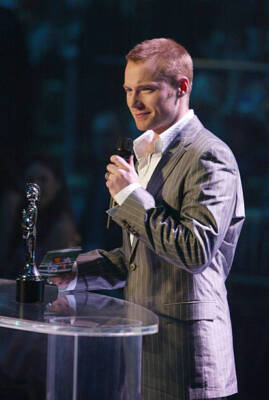 Ronan Keating presents an award on stage at the Brit Awards 2004 - 2004 Photo