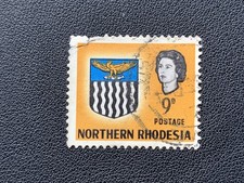NORTHERN RHODESIA ZAMBIA 1963 COAT OF ARMS QUEEN ELIZABETH 9D YELLOW - USED TORN