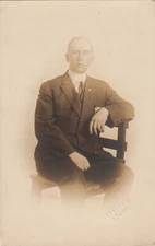 E-382 Man Sitting in Chair Dapper Real Photo RPPC Postcard