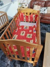 Cot bed for babies, item includes a bright duvet top cover.
