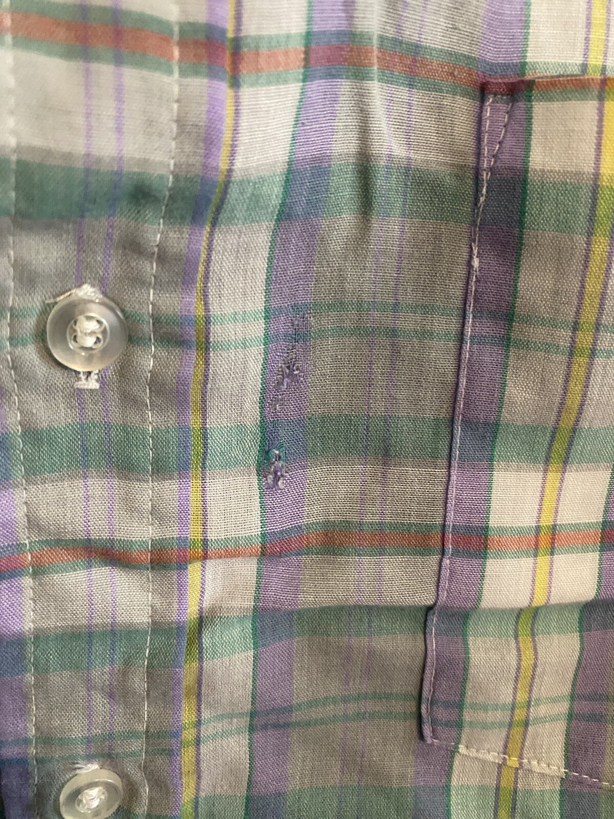 Men’s long-sleeve button-up shirt with green, purple, yellow, and red plaid pattern, featuring two chest pockets.