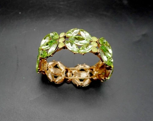 Vintage costume jewelry bracelet with green rhinestones and uranium glass accent