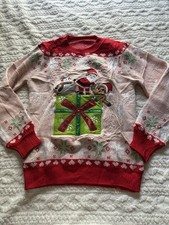 Red and green Christmas sweater with Santa Claus design