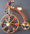 Vintage Gold Tone Prong Set Milk Glass Red White Blue Rhinestone Bicycle Brooch