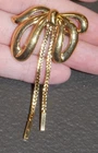 Vintage Monet Polished Goldtone Bow Chain Brooch Costume Jewelry
