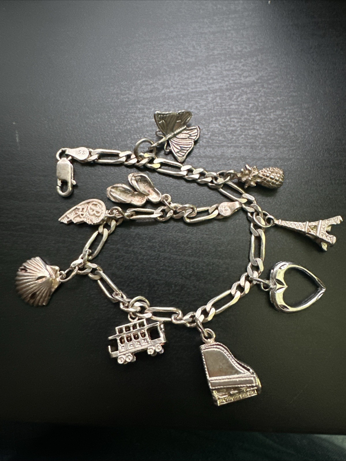 STERLING SILVER CHAIN BRACELET WITH MANY CHARMS. 925