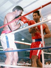 George Forman throws a punch at Ron Lyles at a Heavyweight elimin- 1976 Photo 1