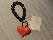 really cute red and black phone chain or charm with heart design.