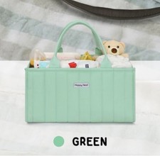 Organize baby essentials with this green diaper caddy with multiple compartments
