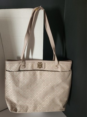 Tommy Hilfiger monogram tote bag features a pastel peach and white color scheme.
