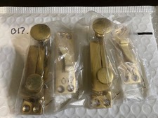 A pair of solid polished brass sash window catches with screws (17)