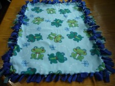 Handmade fleece tie blanket of happy frogs for a small pet