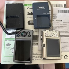 Two Prowershot Canon Cameras, And Two Canon Battery Chargers