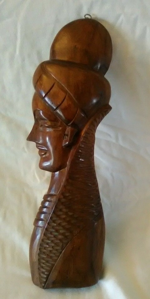 Hand-carved teak tiki sculpture with genuine mid-century craft — the kind of wall art that stops guests mid-sentence.