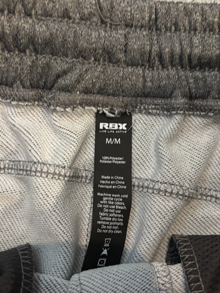 Pantalones de chándal RBX para hombre gris medio con puños con cremallera bolsillos activos gimnasio Foto 2 de 4