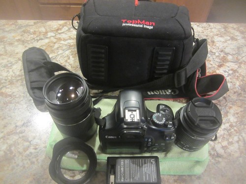 Canon 1100D camera with 2 lenses, battery, charger and carrying case.