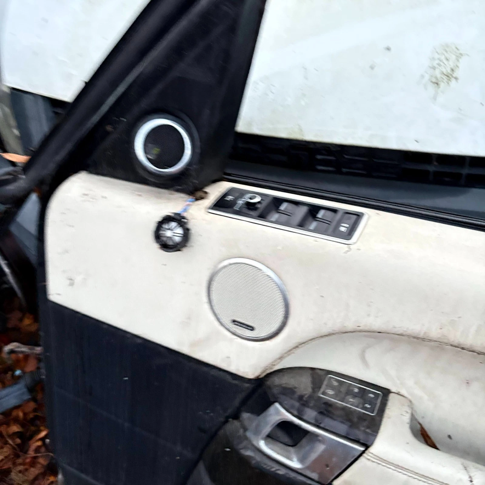 Range Rover L405 driver window mirror switch pack and loose tweeter close-up