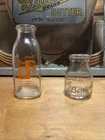 Two vintage pyroglazed glass Bordens milk bottles