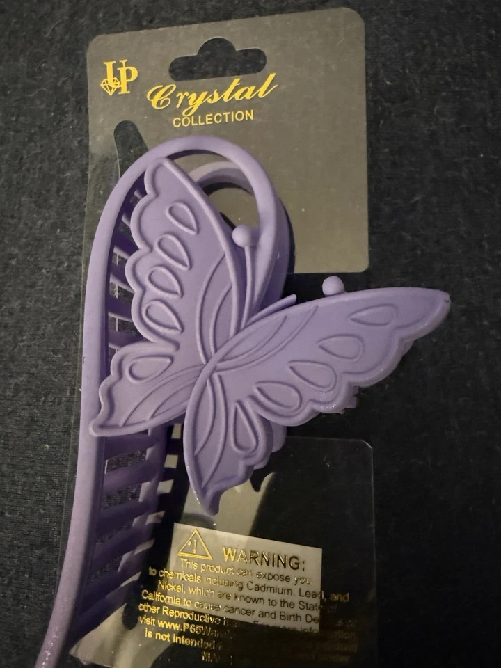 Garra de pelo de mariposa púrpura por cristal Foto 2 de 4