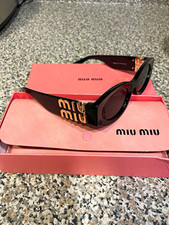 Miu Miu Women s Cat Eye Sunglasses Black Plastic Frame Pink Tinted Logo