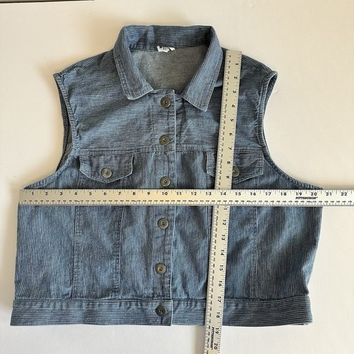 Vintage blue cotton denim vest XL with button front, pointed collar, and flap chest pockets, laid flat on white surface.