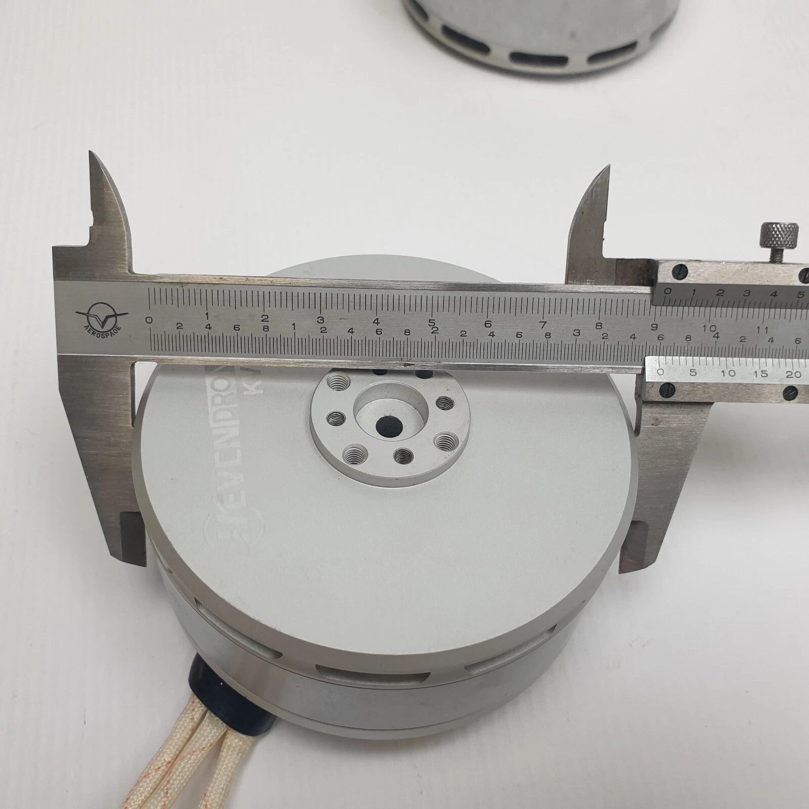 Caliper measuring the diameter of a Heven Drones KV100 motor