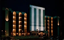 Triton Towers Virginia Beach VA night illuminated ~  1980s postcard