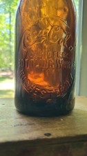 10 oz Amber Coca-Cola(Script) Bottling Works Rochester NY In Slugplate Soda Bott