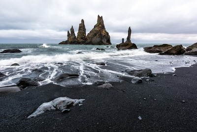 Wandbild: Basalt rock formations Troll toes on black beach. Reynisdrangar, [...]