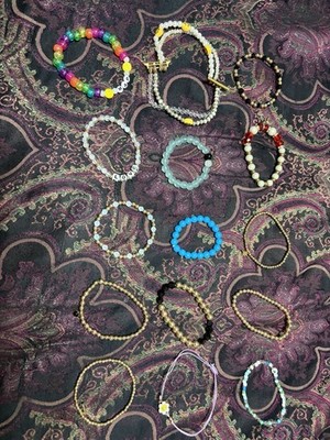 Homemade Charms Bracelet, 13 different pieces ranging from blue to gold.