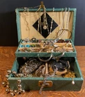 Vintage costume jewelry lot with vintage jewelry box. Broaches, rings and more.