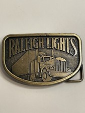 NIP RALEIGH LIGHTS Belt Buckle Trucker Semi Truck Trucking Big Rig Vintage A33