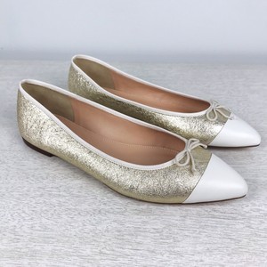 white and gold flats