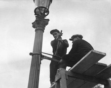 Workers working on a gas lamp in Paris France in 1931 Old Photo