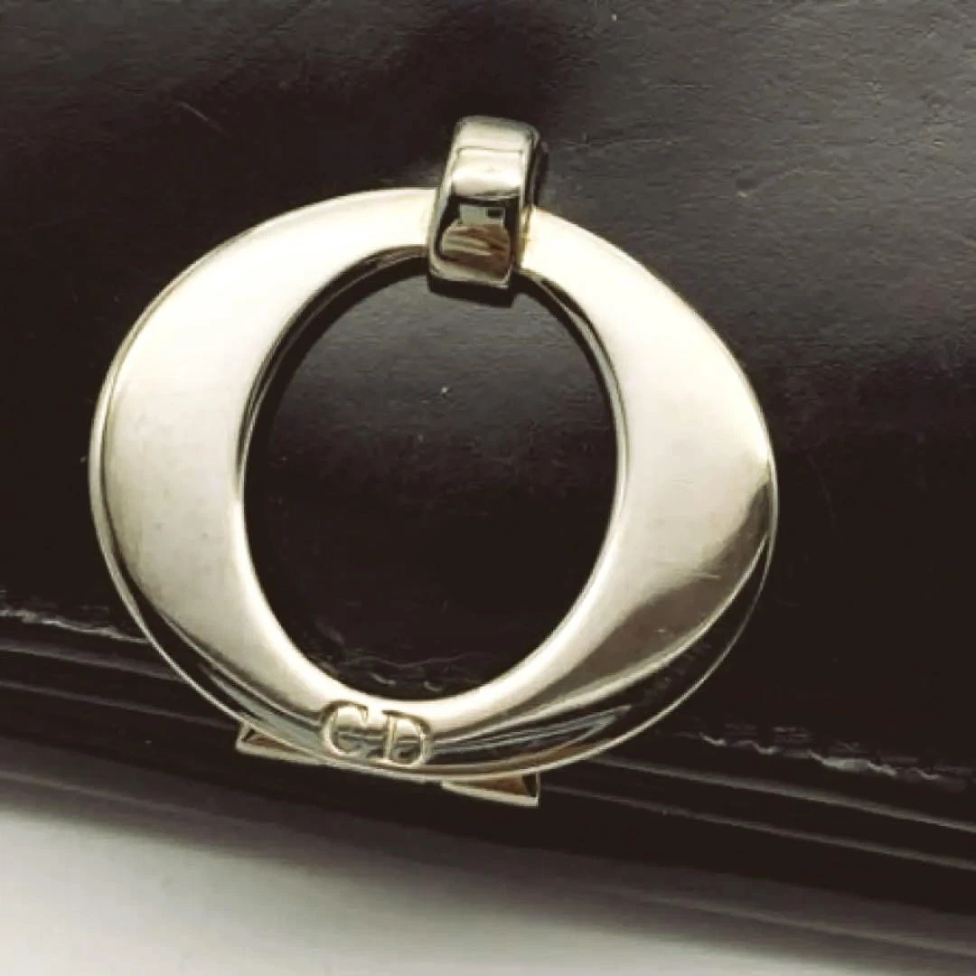 Portefeuille Dior double pli cuir verni noir cercle logo fermoir portefeuille compact