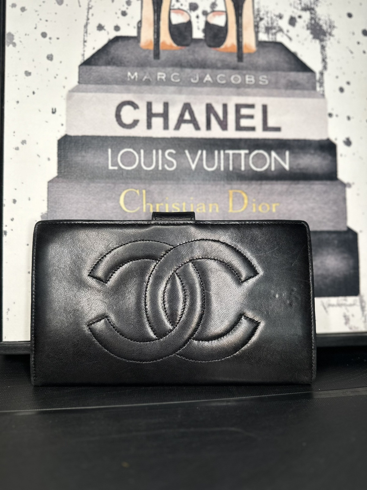Chanel black leather kisslock wallet with gold-tone logo